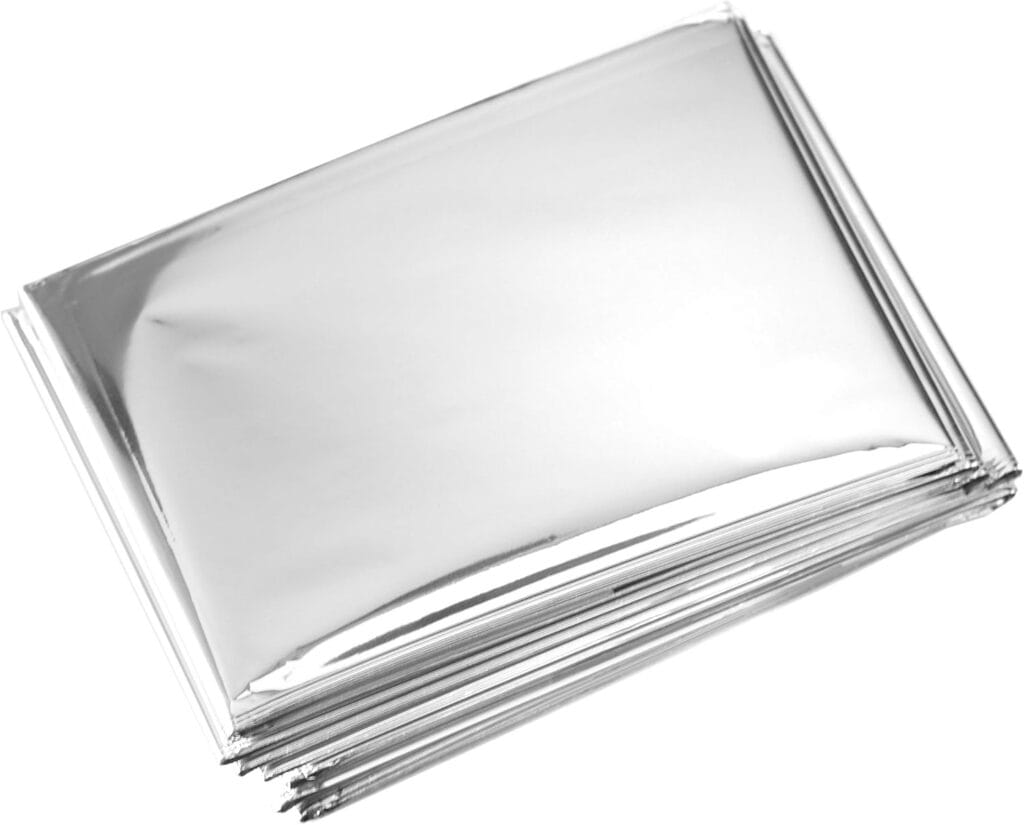 A stack of folded silver emergency thermal blankets is shown against a white background.