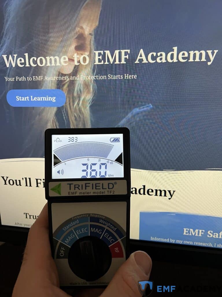 a Trifield TF2 being used to test the EMF radiation levels of a monitor.