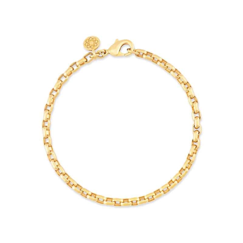 Gold chain bracelet with a lobster clasp and a small circular charm attached.