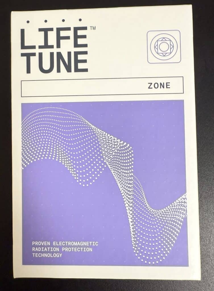 Box labeled LIFE TUNE ZONE featuring a purple abstract design with white dots and lines. Text at the bottom reads Proven Electromagnetic Radiation Protection Technology.