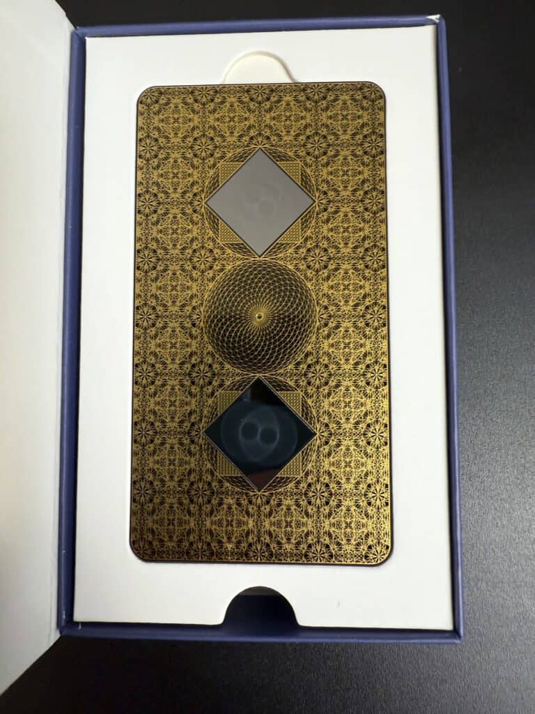 An ornate card with geometric patterns and symbols in a box.