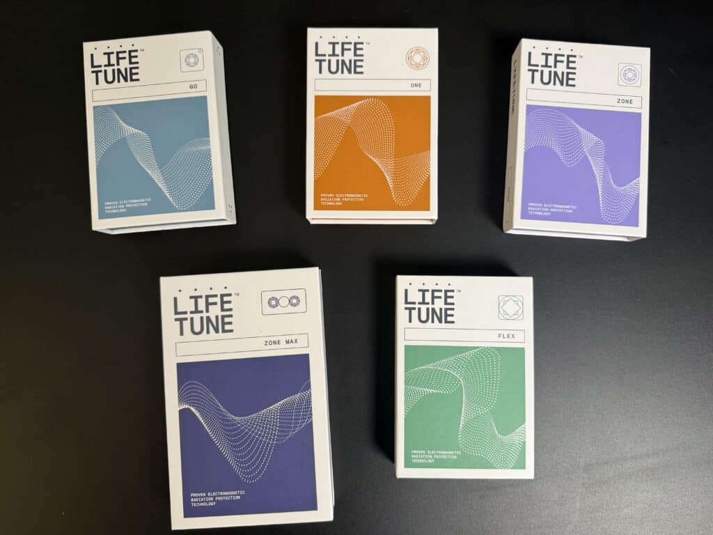 Five Life Tune product boxes in different colors arranged on a dark surface. The boxes feature abstract wave designs and various text details.