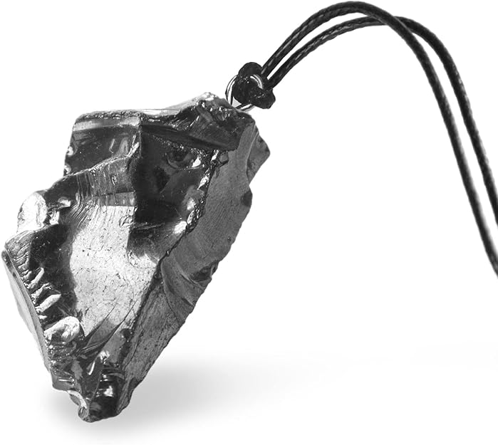 A rough, metallic pendant hangs from a black cord.