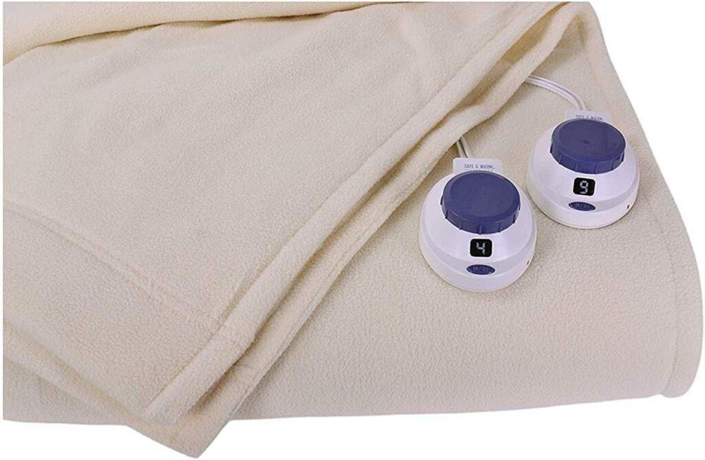 A beige electric blanket with two control dials.