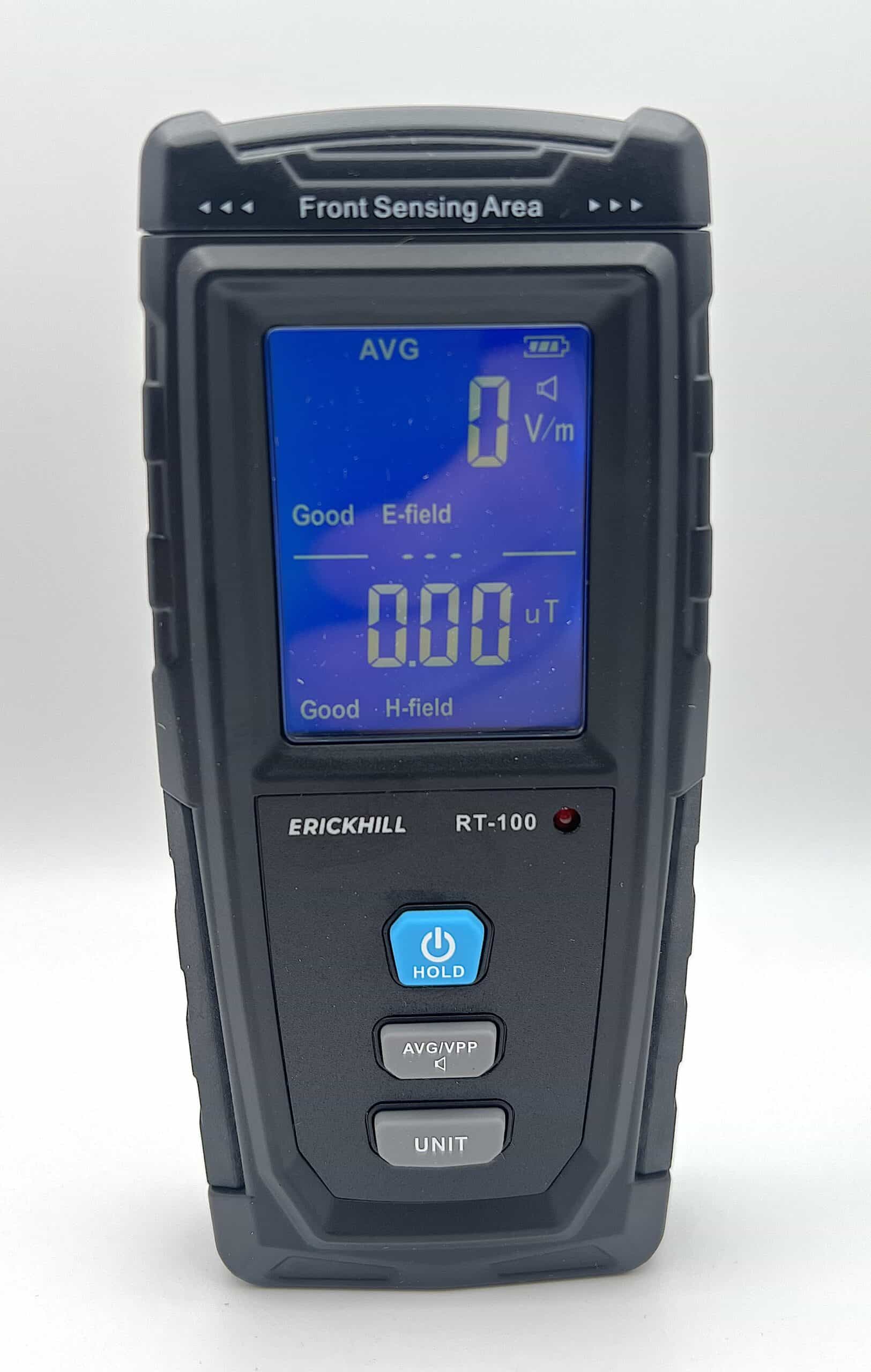 A digital electromagnetic field meter with a blue display showing measurements for electric and magnetic fields. The device is made by Erickhill and is model RT-100