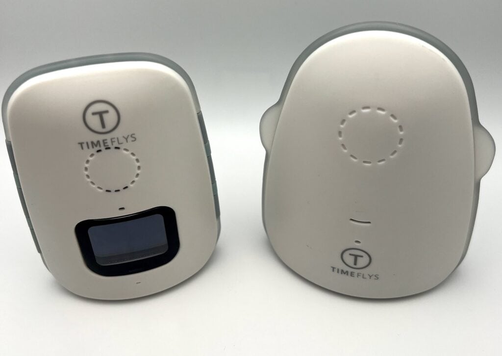 Two white and gray baby monitor units with TIMEFLYS branding. One has a small screen, and the other is rounded with a smooth surface.