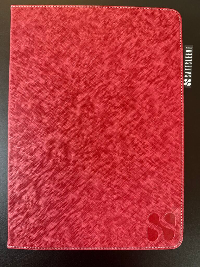 Red spiral-bound notebook with SPARKLETONE and double S logo on the cover, placed on a dark surface.