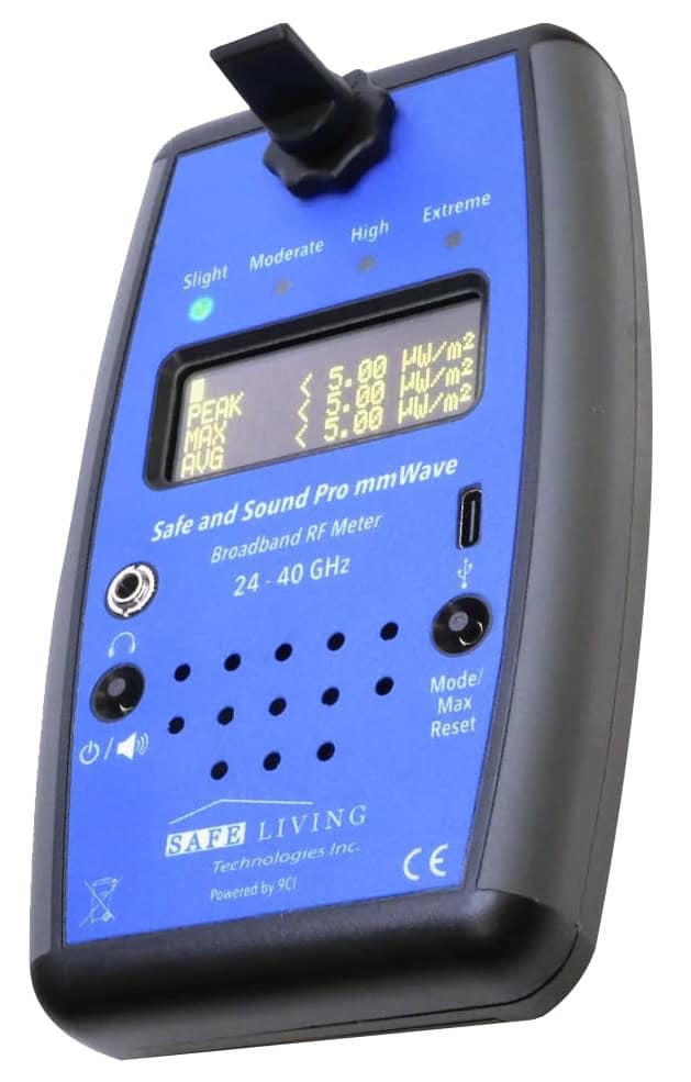 A handheld blue and black broadband RF meter with a display screen showing measurements, labeled buttons, and an antenna on top.