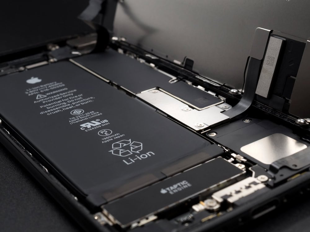Close-up view of the internal components of a smartphone, showing the battery, circuitry, and connectors inside an open device.